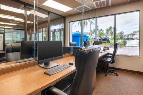 an office with a desk with two monitors and chairs at Hilton Vacation Club Aqua Sol Orlando West in Orlando