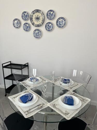 a glass table with blue and white plates on it at Viareggio, Sweet home in Viareggio