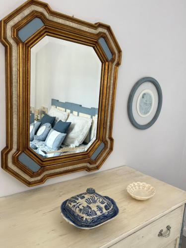 a mirror sitting on top of a wooden dresser at Viareggio, Sweet home in Viareggio