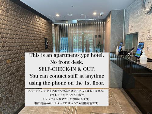 a sign on a wall in a room at FLOWER TERRACE Higashi Shinjuku in Tokyo