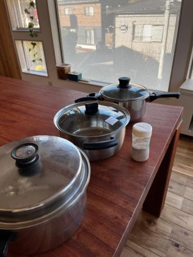 a group of pots and pans on a wooden counter at Toraya Attic in Shimoda