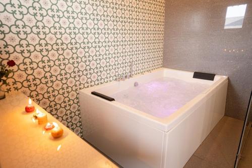 a white bath tub in a bathroom next to a table at Mogvilla 10bedrooms super luxurious, marna, siolim in Marna