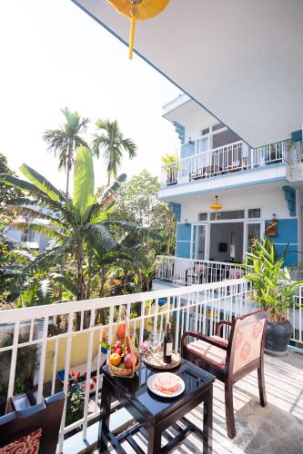 a balcony with a table with fruit on it at Lucky Leaf Hoian Villa in Hoi An