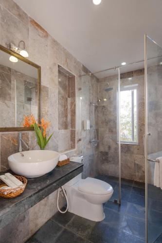 a bathroom with a toilet and a sink and a shower at Lucky Leaf Hoian Villa in Hoi An