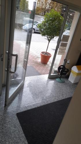 an open door of a building with a plant outside at Hotel Residence La Fontana in Mariano Comense