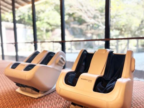 two empty chairs sitting on the floor in a room at Nisshokan Bettei Koyotei in Nagasaki