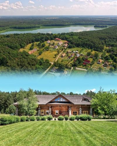 an aerial view of a large house with a lake at Ułańska Zagroda in Człopa