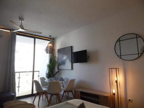 a living room with a table and chairs and a window at Puerto Marina in Benalmádena