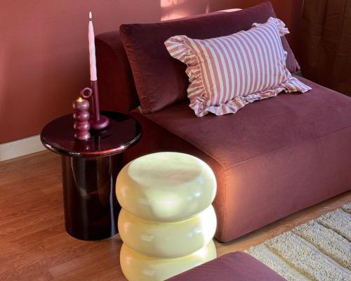 a living room with a couch and a candle on a table at Retro Apartment Shared Stay & Go Enschede in Enschede