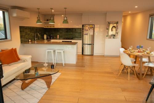 a living room and kitchen with a couch and a table at Golden Hour Villa in Queenstown