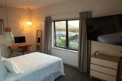 a hotel room with a bed and a window at Golden Hour Villa in Queenstown