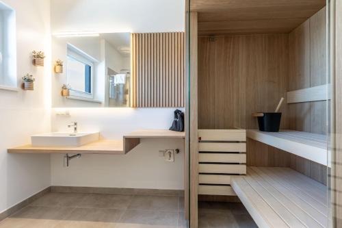a bathroom with a sink and a mirror at Alpine Suite Spot in Bad Mitterndorf
