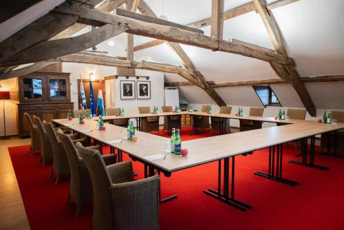 a large room with a long table and chairs at Chateau d'Urspelt in Urspelt