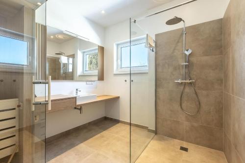 a bathroom with a shower and a sink at Alpine Suite Spot in Bad Mitterndorf