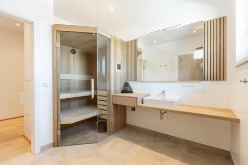 a bathroom with a sink and a shower at Alpine Suite Spot in Bad Mitterndorf