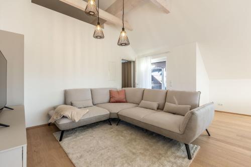 a living room with a couch and a rug at Alpine Suite Spot in Bad Mitterndorf