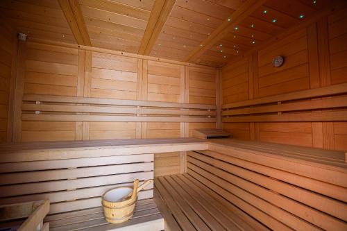 a large wooden sauna with a bucket in it at Apartments Maleric with Indoor Pool and Wellness in Dragatuš