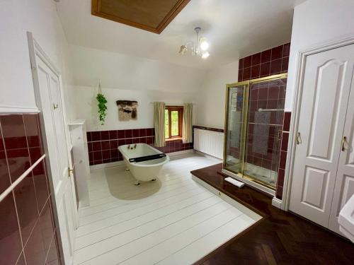 a bathroom with a tub and a toilet in it at Idyllic Historical Country Retreat in Elkstone - Pass the Keys in Warslow