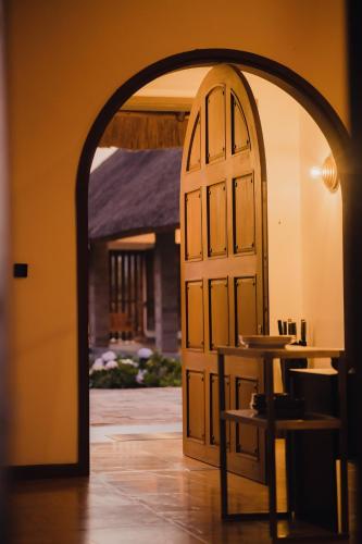 an archway leading into a room with a table at Tabebuia Spa and Safari Resort in Fort Portal