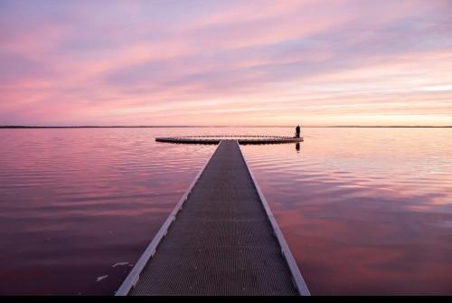 a dock in the middle of a body of water at Woomelang Cabin Silo Trail Two Bedroom Cabin Queen and KSing in Woomelang
