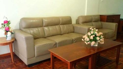 a living room with a couch and a coffee table at Star Regency 2 Rooms Apt, Brinchang Town in Cameron Highlands