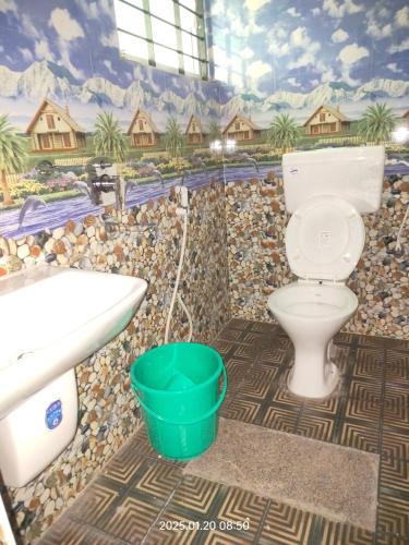 a bathroom with a toilet and a sink at Amruth Homestay Honavar room 2 in Honāvar