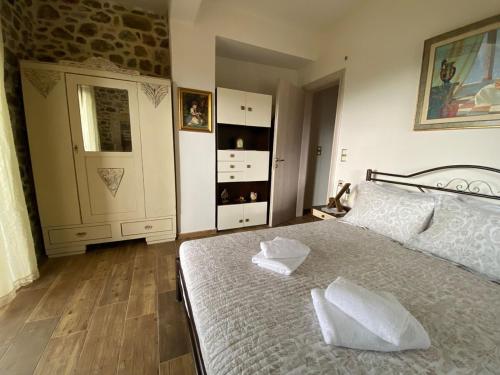 a bedroom with a bed with two pillows on it at Villa Fragk in Nipiditos village in Arkalochori