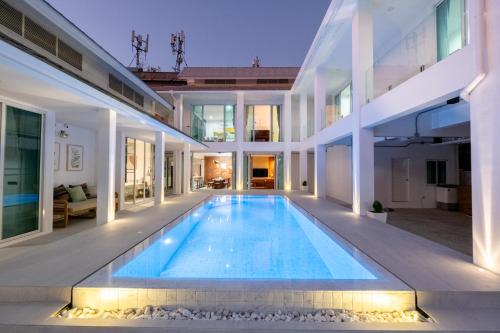 an indoor swimming pool in a house at White Pool Villa Chiangmai in Chiang Mai