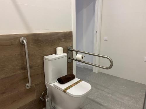 a bathroom with a toilet with a towel on it at Apartments Vent de Vela in Valencia
