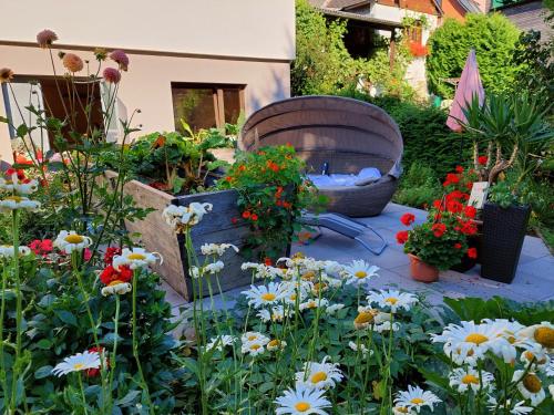 a garden with flowers and a fire place at Gästehaus Daurer in Reinsberg