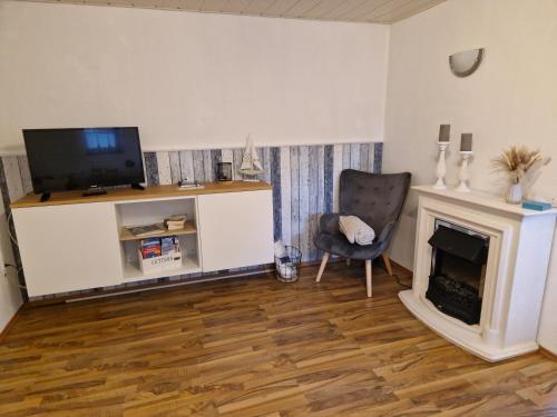 TV a/nebo společenská místnost v ubytování Wohnung Nordseebriese