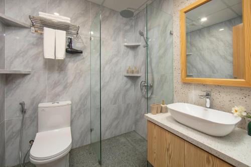 a bathroom with a toilet and a sink and a shower at Westlake Pearl Apartment - Hotel & Pearl Spa in Hanoi
