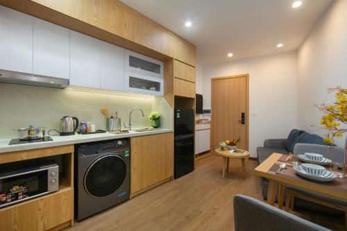 a kitchen and a living room with a washer at Westlake Pearl Apartment - Hotel & Pearl Spa in Hanoi