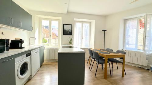 une cuisine et une salle à manger avec une table et des chaises dans l'établissement Bel appartement au cœur de Strasbourg, à Strasbourg