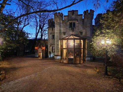 an old castle with a gazebo in front of it at Entire Castle & Grounds for 18, Banquet Hall & BBQ in Trowbridge