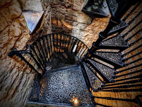 an overhead view of a spiral staircase in a building at Entire Castle & Grounds for 18, Banquet Hall & BBQ in Trowbridge