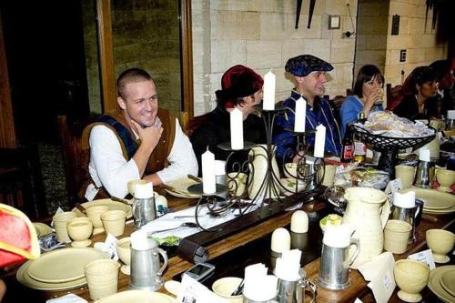 a group of people sitting around a table with pottery at Entire Castle & Grounds for 18, Banquet Hall & BBQ in Trowbridge