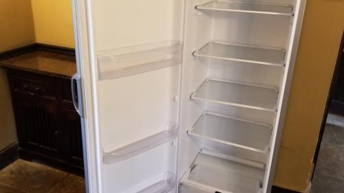 a white refrigerator with its door open in a kitchen at Entire Castle & Grounds for 18, Banquet Hall & BBQ in Trowbridge