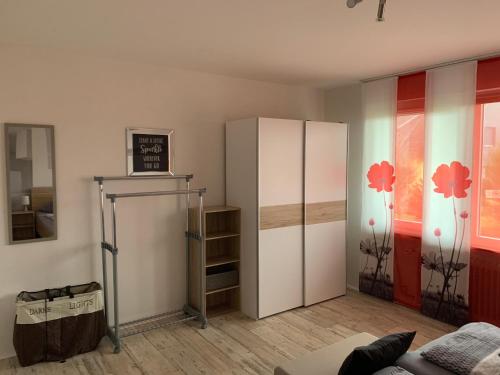 a living room with a large white refrigerator at Ferienhaus am Geiersberg in Walkenried
