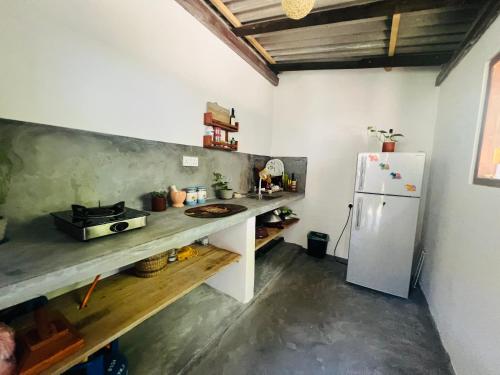 a kitchen with a counter and a refrigerator at Moon Bay in Mirissa