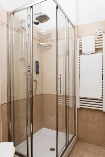 a shower with a glass enclosure in a bathroom at Hotel City in Montesilvano