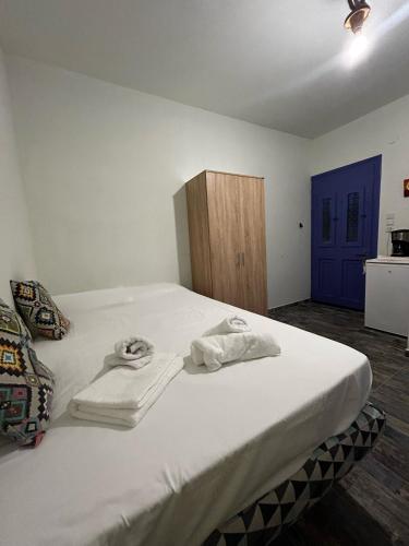 a bedroom with a bed with towels on it at Astypalea Castle Apartments in Astypalaia