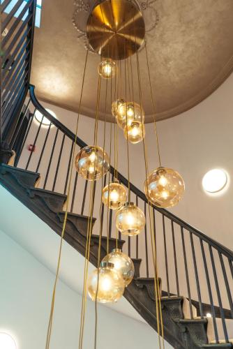 a bunch of lights hanging from a ceiling at Stunning Town Centre Apartments with Spa facilities in Morpeth