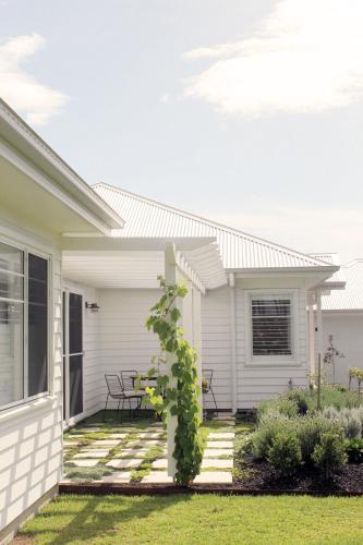 a white house with a patio with a table at Luxury house, close to weddings! in Worragee