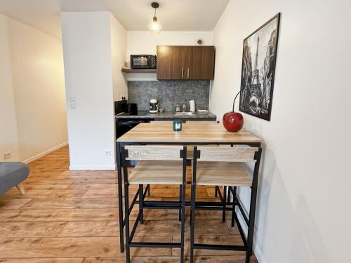 - une cuisine avec un comptoir et une table dans une pièce dans l'établissement Cosy Studio Disneyland Paris - Rentaway BnB, à Montévrain