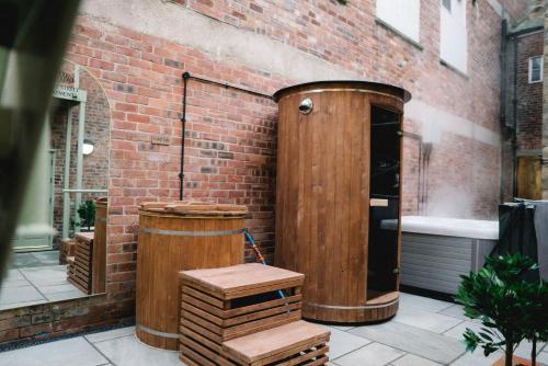 a wooden structure sitting next to a brick building at Stunning Town Centre Apartments with Spa facilities in Morpeth