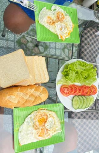 a table topped with different types of food on plates at HOMESTAY Hoàng GIa in Ấp Ông Tú
