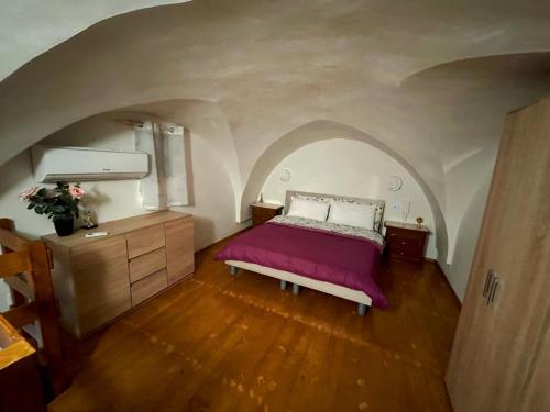 a bedroom with a bed in an arched ceiling at La casa sotto il castello! in Carovigno