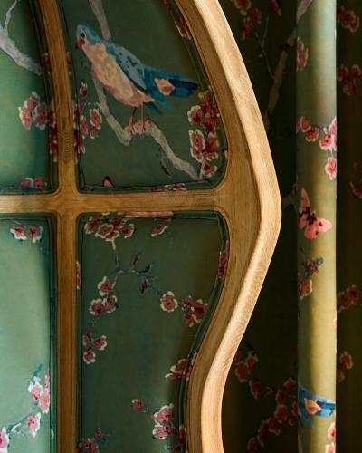 a mirror with a painting of a bird on the wall at Nuvole Garden Hotel in Brunate