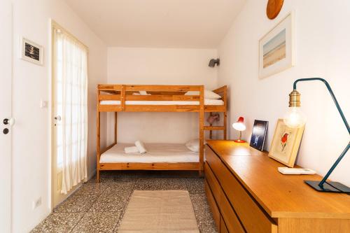 a bedroom with two bunk beds and a desk at CASA ROSALIE VI4442 By Riviera Holiday Homes in Villefranche-sur-Mer